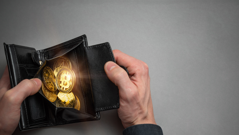 Cryptocurrency coin bitcoin in a black wallet.