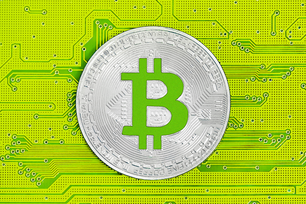 Bitcoin on yellow circuit board. Bitcoin cryptocurrency on computer electronic circuit board. Cybercrime background