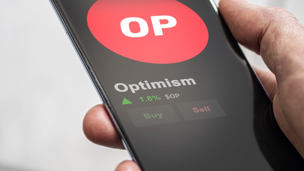 An investor analyzing the price of Optimism, the token coin $OP on a crypto exchange sreen.