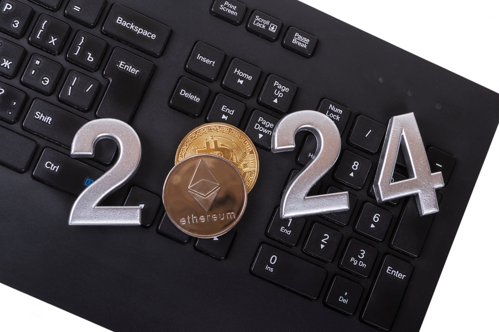 2024 is laid out in numbers on a laptop. the concept of the rise or fall of crypto. Bitcoin is lying nearby