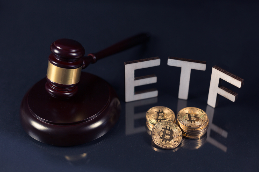 Bitcoin coins with ETF text and gavel put on dark background, Concept of the approval of Exchange Traded Fund.