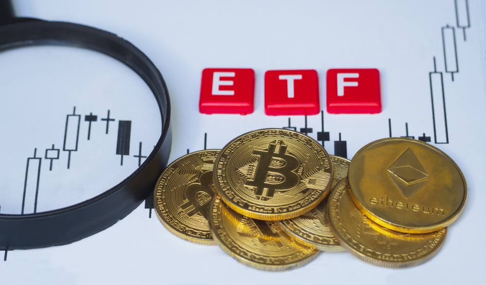 Crypto Currency bitcoin coin With ETF text and magnifying glass placed on paper with a candlestick chart, Concept Determining the tax law of digital money.