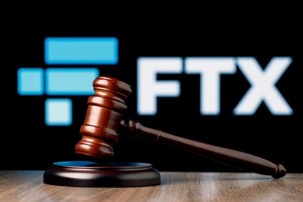 FTX is cryptocurrency exchange. Gavel on table against background of FTX logo. The concept of trial.