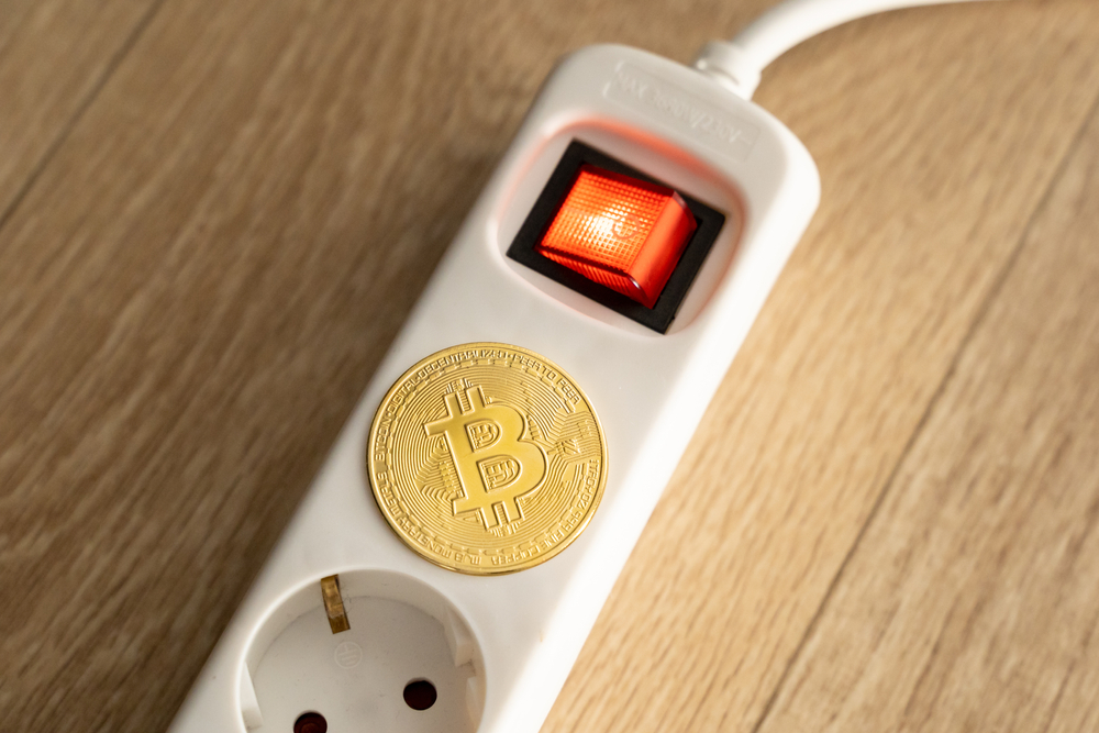 Bitcoin lying on a power supply socket. 