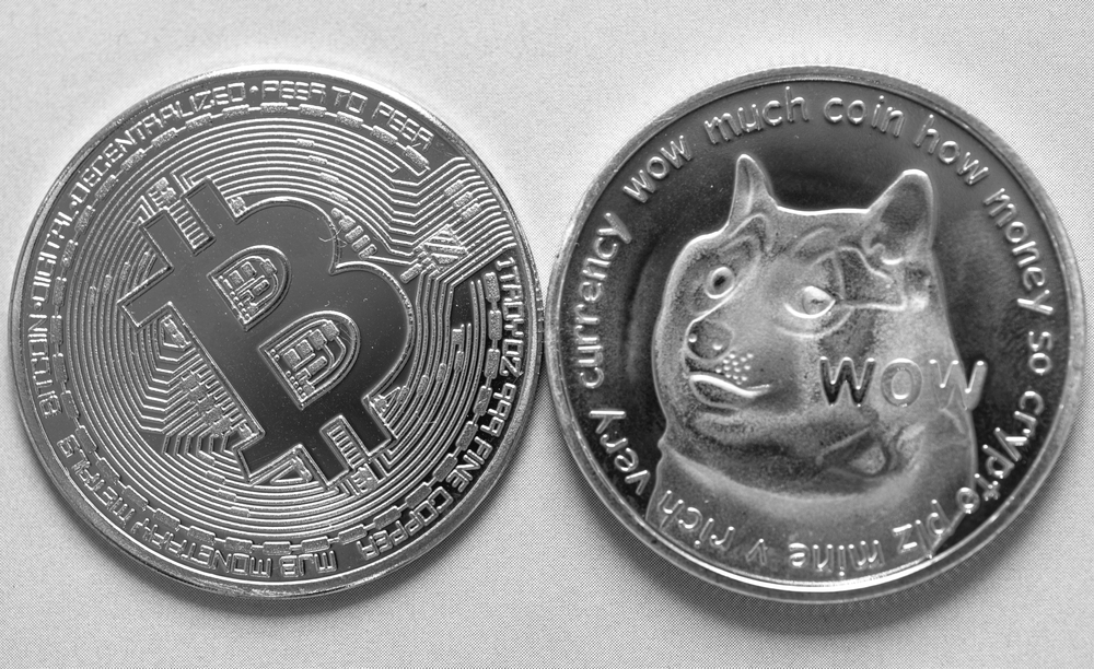 Dogecoin and Bitcoin cryptocurrency in black and white tone close up photo