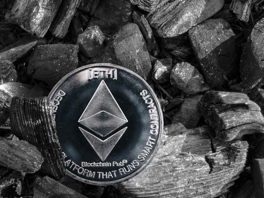 The cryptocurrency Ethereum coin lies on coal. Mining and Energy for mining.