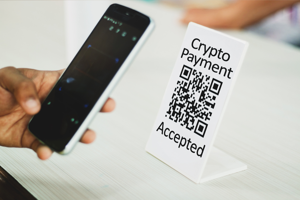 Close up of hands paying using mobile phone Scaning crypto QR code digital contact less payment after shopping using cryptocurrency - concept of technology, safety and privacy