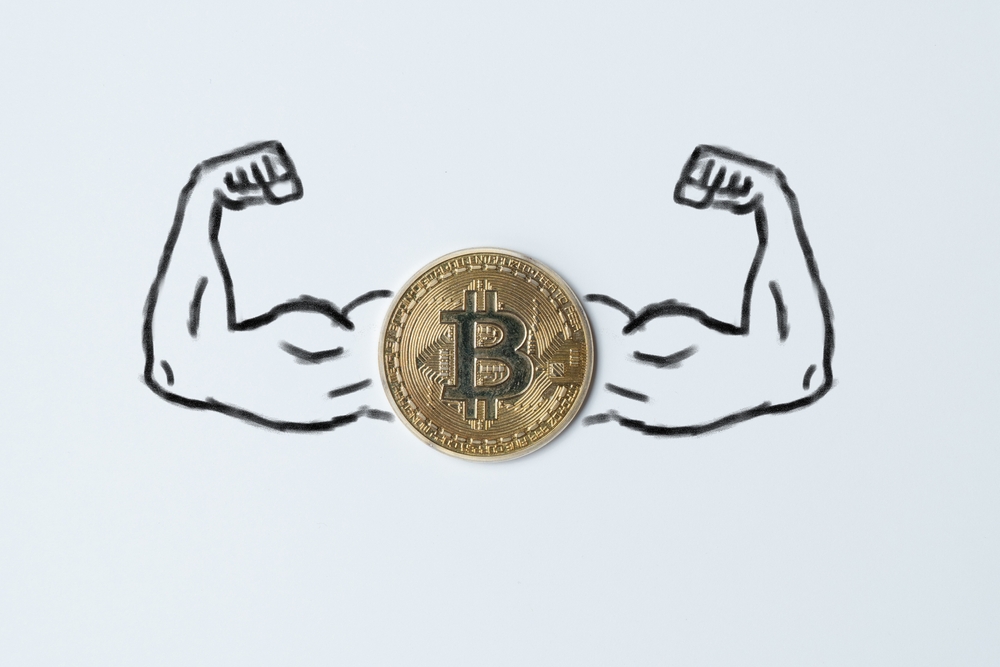 The concept of a strong cryptocurrency bitcoin. Arms muscles drawn with a coin