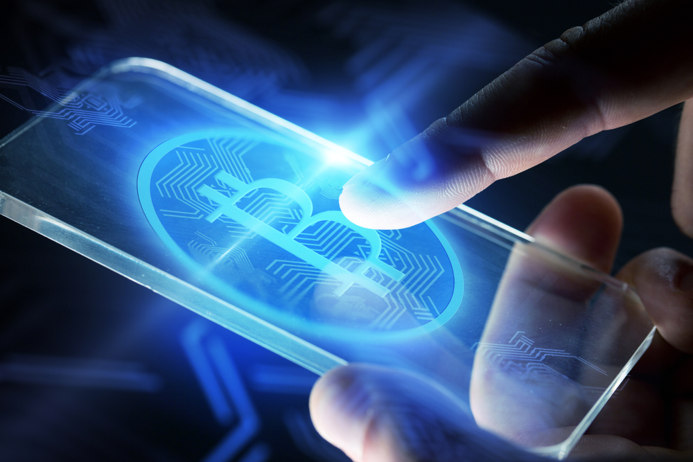 business, cryptocurrency and future technology concept - close up of hands with virtual bitcoin symbol hologram transparent smartphone screen over black background