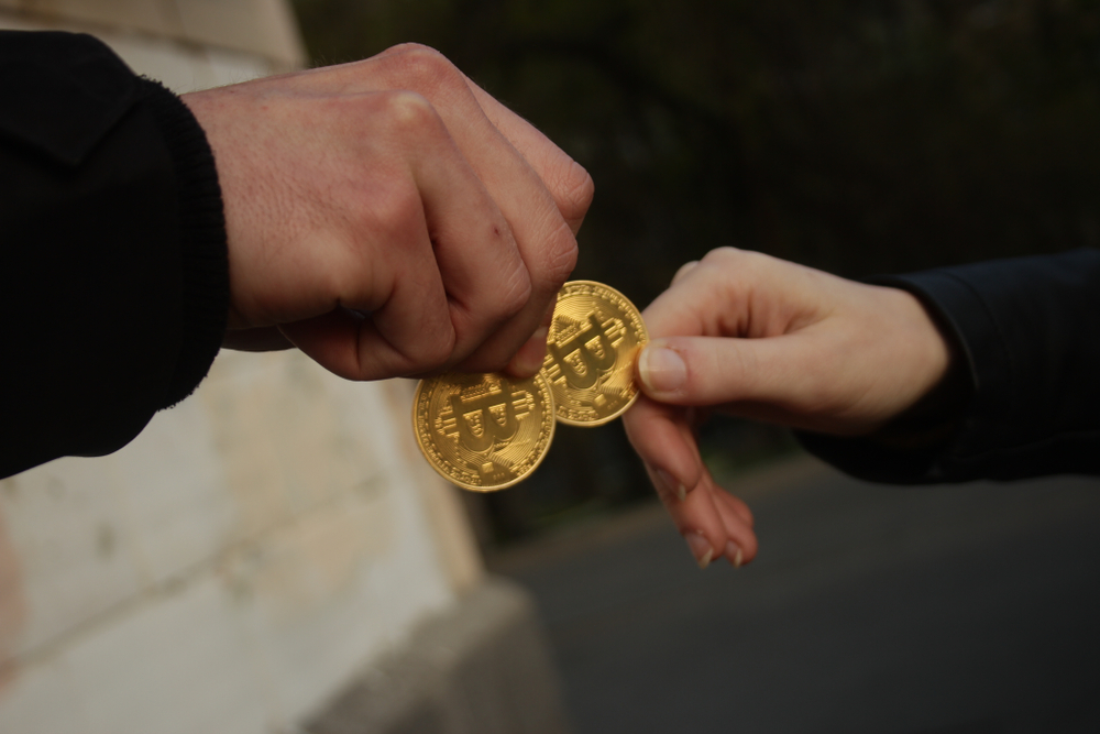 Bitcoin golden coin is passed from hand to hand. Concept: bitcoin transaction, payment in crypto, anonymous exchange.