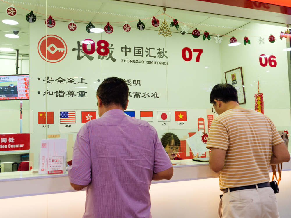 View of Chinese nationals at the counter of a money transfer remittance company.