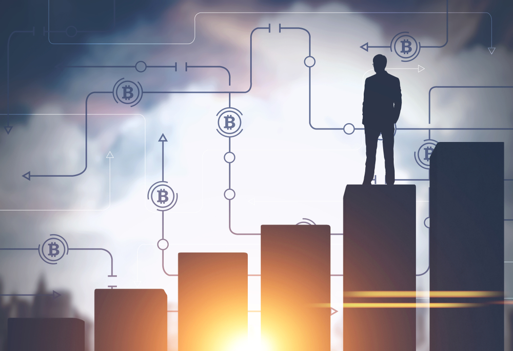 Businessman standing on a giant bar chart in a morning city.