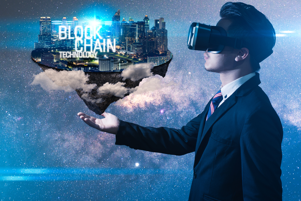 The abstract image of the business man hold the blockchain hologram on hand.