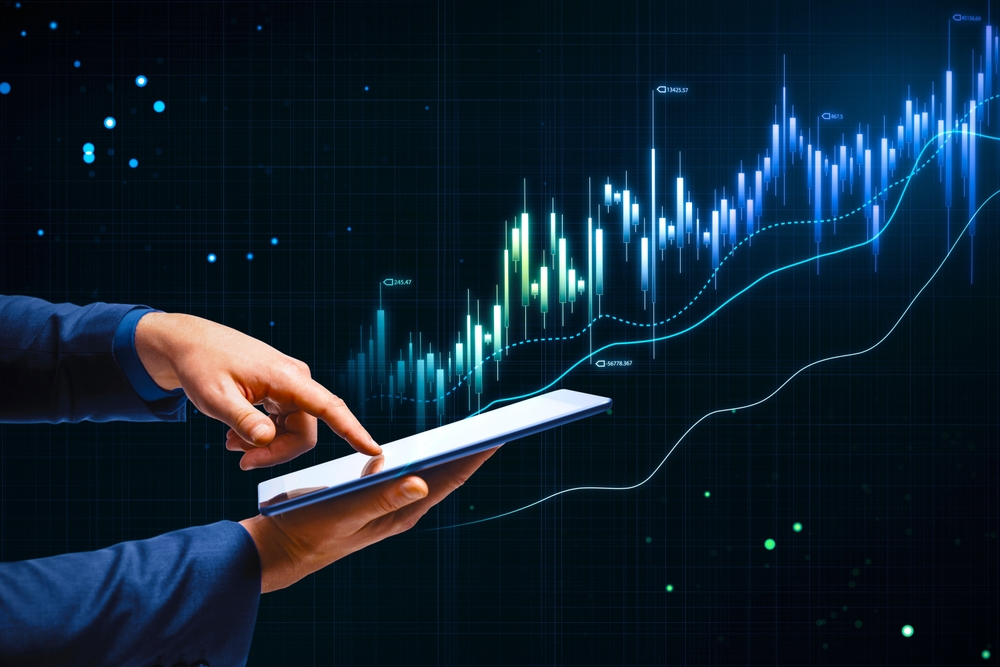 Online trading, investing and stock market concept with man finger on digital tablet touch screen and glowing rising financial chart candlestick and diagram on dark technological background