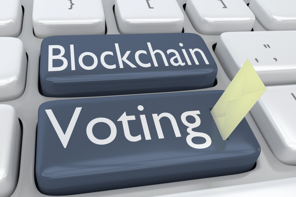 3D illustration of computer keyboard with the script Blockchain Voting on two adjacent gray buttons, and a voting envelope inserted into one of these bottons.