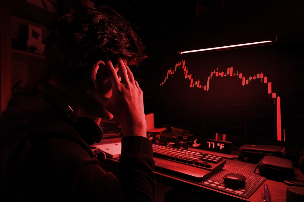 Stress Business man look at the Computer Screen, The red crashing market volatility of crypto trading with technical graph and indicator, red candlesticks going down without resistance, market crash