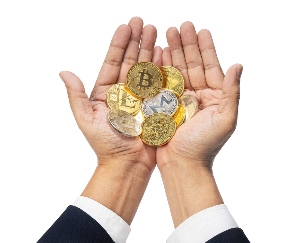 Investment concept, Businessman holding a coin and bitcoin symbol Currency sign isolated on white background, Shiny golden physical cryptocurrencies Bitcoin symbol coins on white With clipping path.