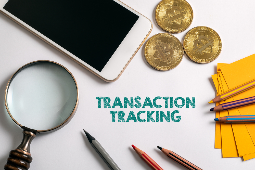 Transaction Tracking. Banking transactions, purchase and sale of cryptocurrencies. Office supplies on a white table