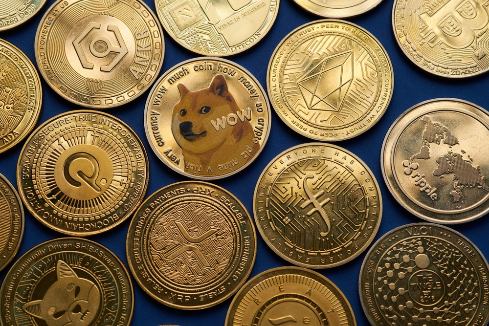 Closeup of golden Dogecoin coin and various cryptocurrencies