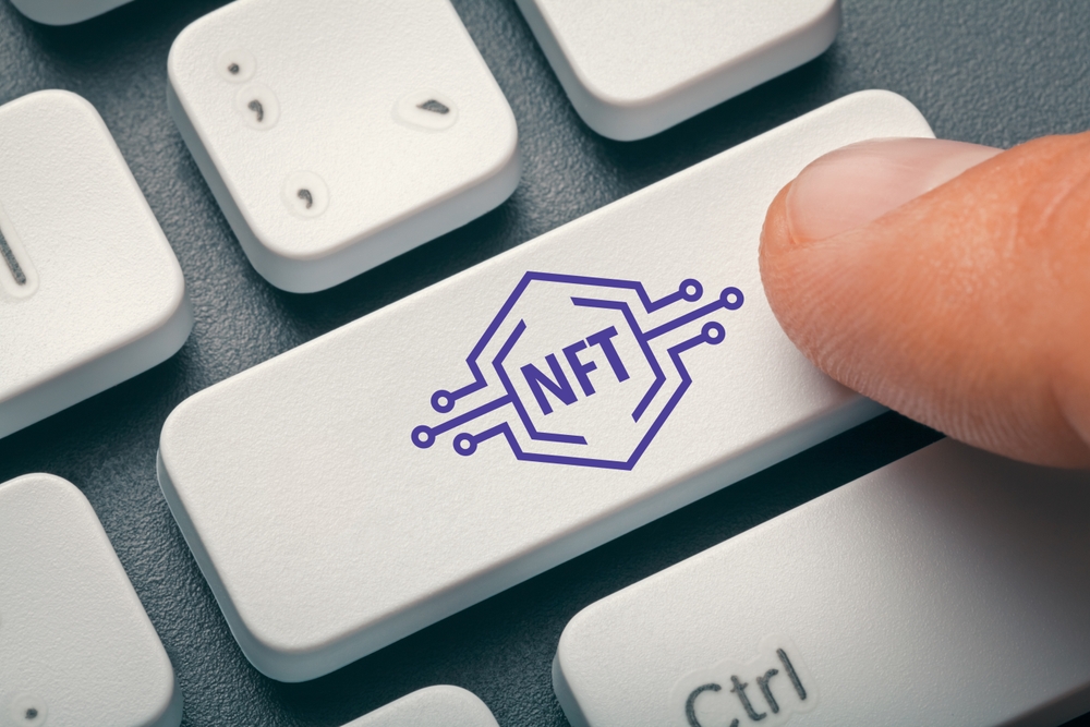 Close-up photo of index finger pressing computer key with NFT symbol. Electronic Non-Fungible Token concept. Photo Formats