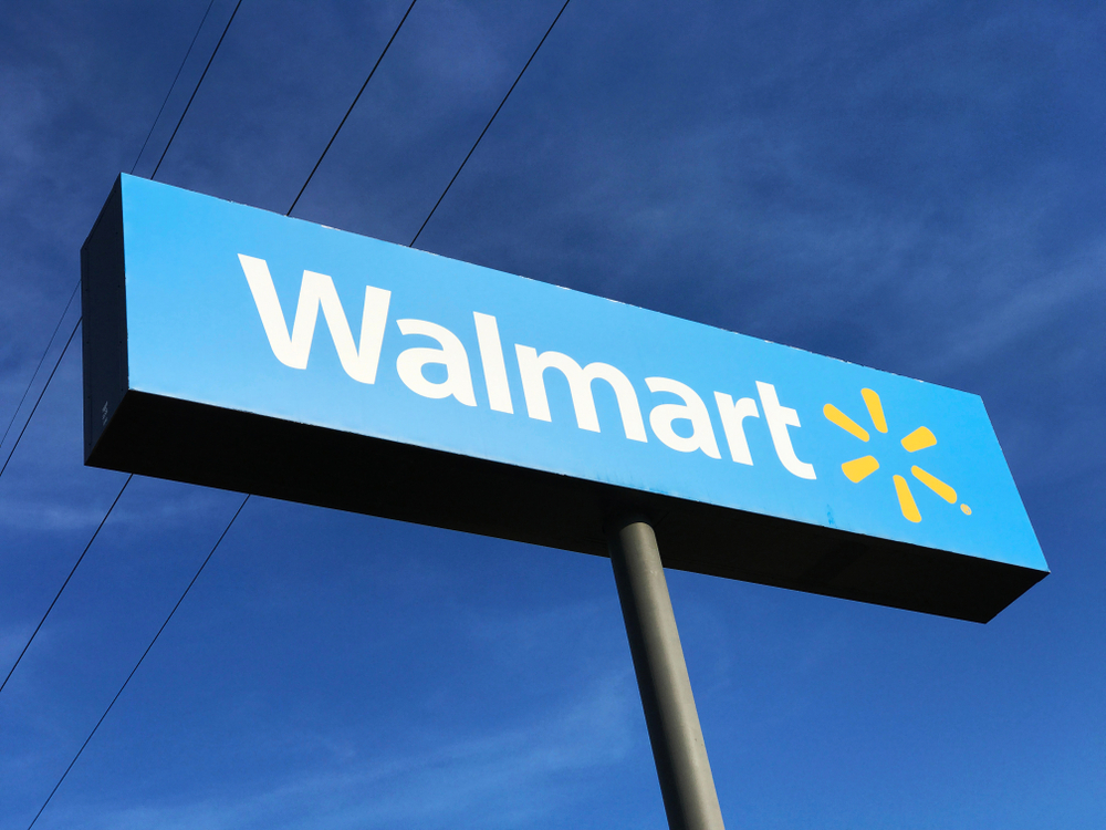 The exterior Sign of a Walmart retail store in Minnesota. Walmart recently launched a partnership with IBM Blockchain Technology to improve food safety.