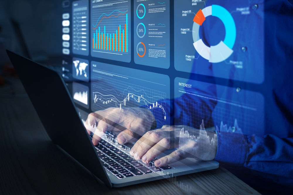 Analyst working with Financial Report and Business Analytics Dashboard on laptop computer to analyze Financial Data with KPI and Metrics.