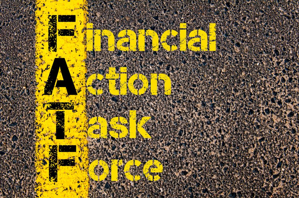 Concept image of Business Acronym FATF as Financial Action Task Force written over road marking yellow paint line.