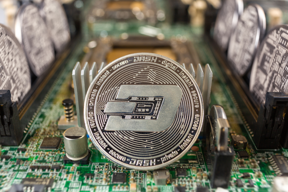 Dash coin close-up on a computer circuit motherboard as a blockchain technology payment network.