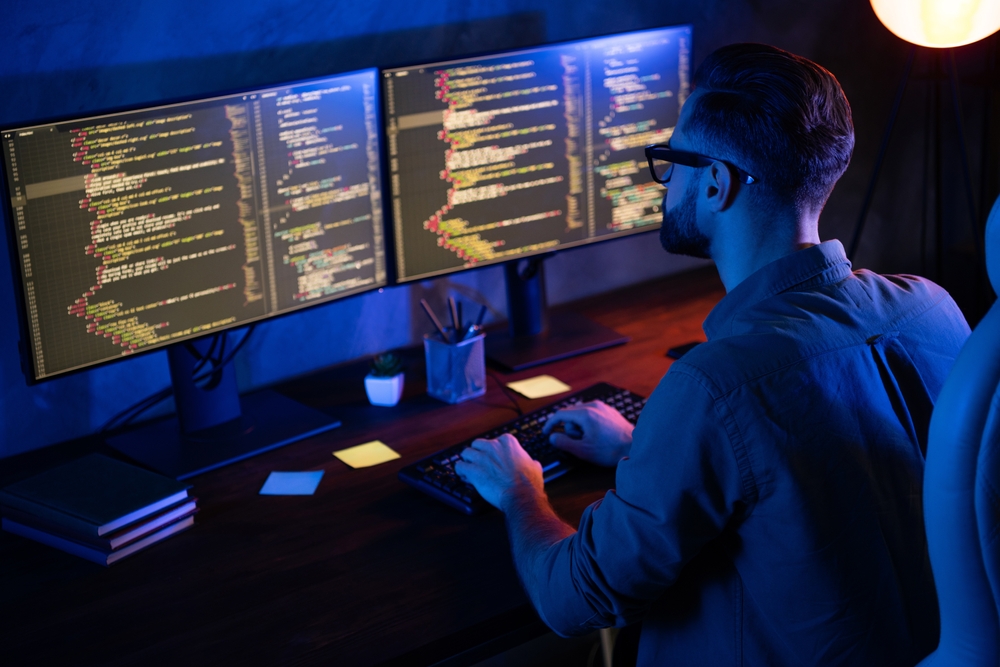 Rear photo of smart skilled introvert tester write typing operating data security evening house dark room