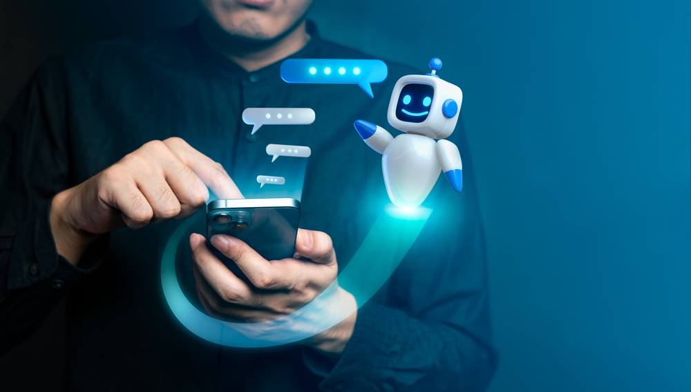 Person using a smartphone to interact with a friendly AI chatbot, illustrating modern technology and digital communication.
