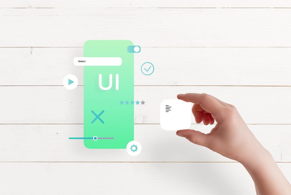Top view of hand assembling app interface on table, placing text box, concept of UI UX design and mobile app development